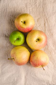 Fresh sweet apples on reusable textile grocery bag on dark grey background, top view