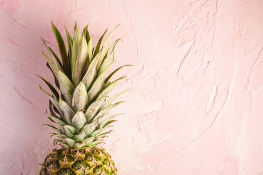 Fresh sweet pineapple on pink textured background, top view copy space, cropped