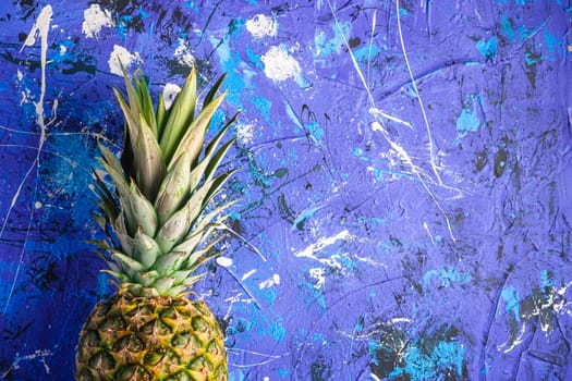 Fresh sweet pineapple on blue textured background, top view copy space