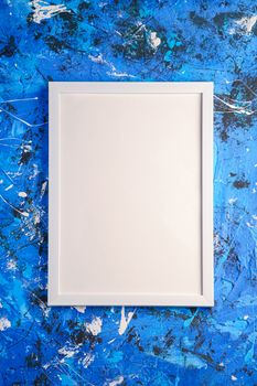 White empty template picture frame on textured blue background, top view, mockup copy space