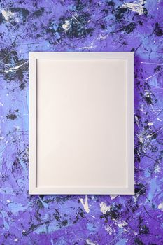 White empty template picture frame on textured blue and purple background, top view, mockup copy space