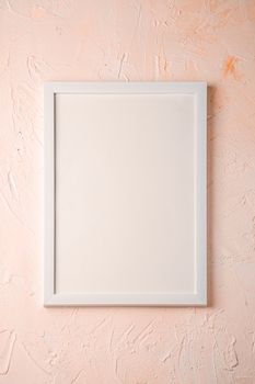 White empty template picture frame on textured bright, cream and peach background, top view, mockup copy space