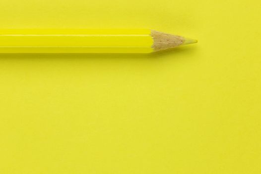 One yellow pencil on a yellow background ,beautiful monochromatic effect