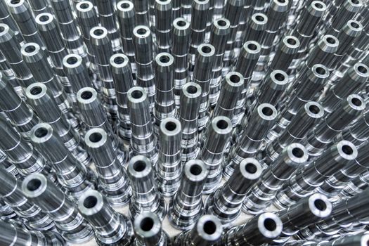 Shiny long steel parts full frame background, clean steel threaded rods after fine cnc turning.