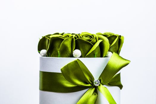 Green roses in a round luxury present box. Bouquet of flowers in a paper box isolated.