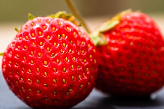 Close up of fresh strawberries showing seeds achenes. Details of fresh ripe red strawberries.