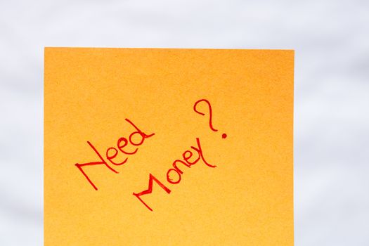 Need money handwriting text close up isolated on orange paper with copy space.