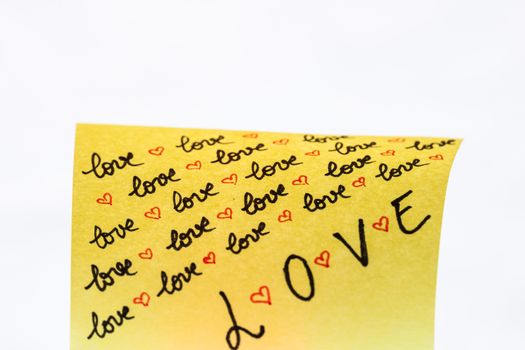Love handwriting text close up isolated on yellow paper with copy space.