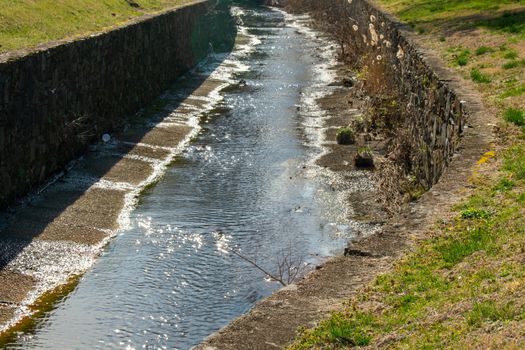 A Man-Made Canal With Cobblestone Walls for Drainage and Overflow