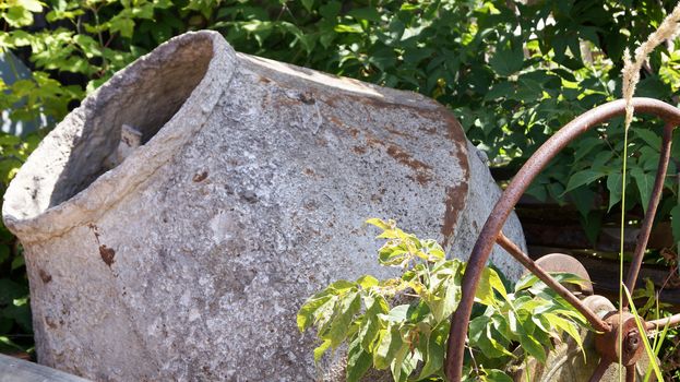 old rusty concrete mixer in the grass