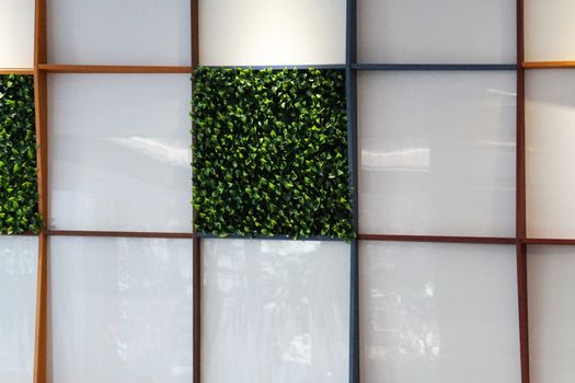 wall made of artificial green plants and organic glass , artificial landscaping in the interior