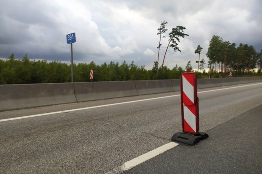 broken road sign on an empty track on a curtain day.