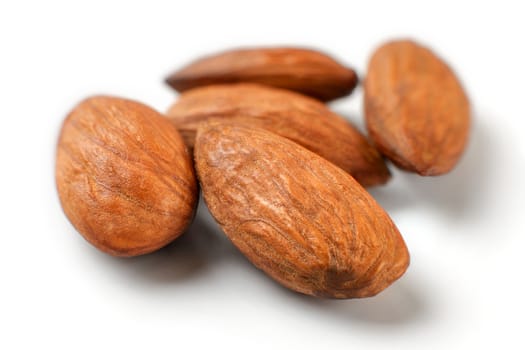 Pile of almond nuts isolated on white background.