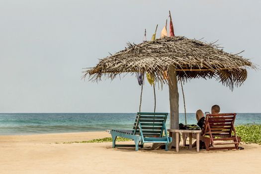 A guy is relaxing at Bentota beach in Sri Lanka.