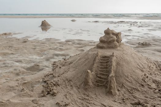 Temple of sand on the beach. Like a sandcastle. Bentota Beach in Sri Lanka.