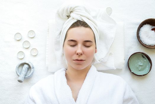 Spa and wellness. Natural cosmetics. Self care. Top view of a relaxed woman having spa procedures using natural cosmetics