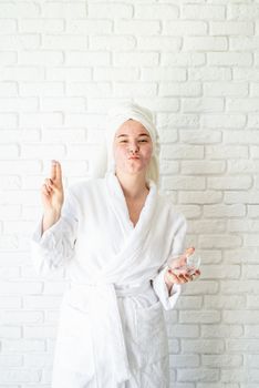 Spa and wellness. Natural cosmetics. Self care. Happy young woman applying face scrub on her face