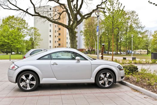 A sporty silver car parked on a parking lot. Leherheide Bremerhaven, Germany.