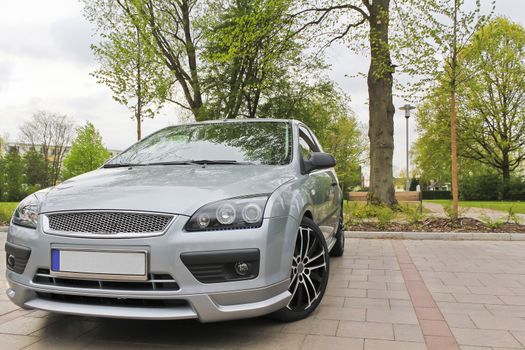 A sporty silver car parked on a parking lot. Leherheide Bremerhaven, Germany.