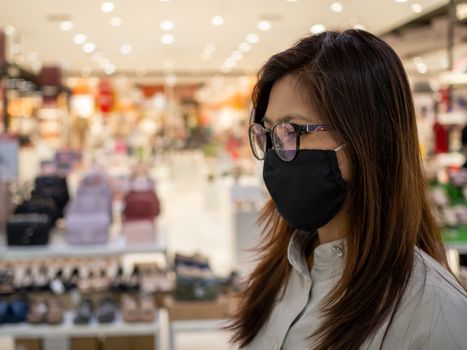 Portrait of a woman wearing a protective mask Walk in shopping mall