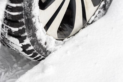 Car in the snow. Closeup of car tires in winter