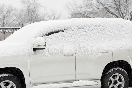 Car in the snow. Parked car covered with snow