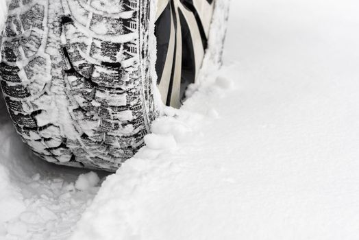 Winter tires closeup. Car in the snow