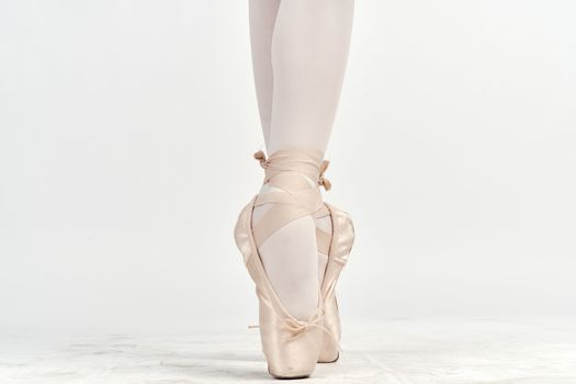 Ballerina's feet pointe shoes dance performing exercise. High quality photo