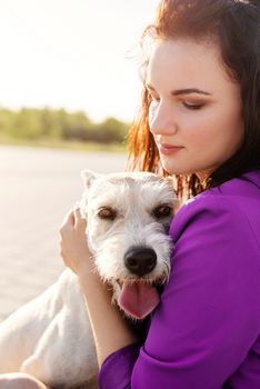 Pet care. Pet adoption. Young woman hugging her mixed breed dog