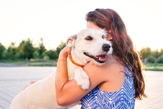 Pet care. Pet adoption. Young woman hugging her mixed breed dog