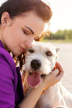 Pet care. Pet adoption. Young woman hugging her mixed breed dog