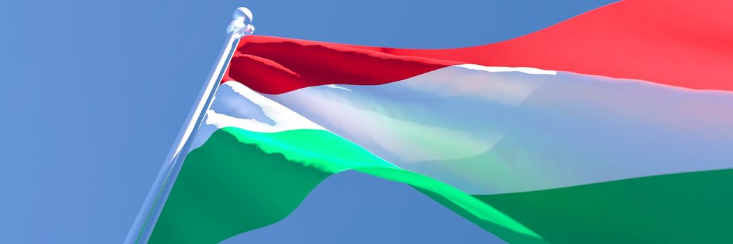 3D rendering of the national flag of Hungary waving in the wind against a blue sky.