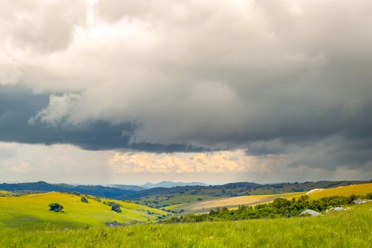 Dramatic landscape and rolling hills under thunderstorm clouds in Nyika National Park in Malawi, Africa