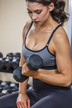 A brunette fitness model preparing to work out