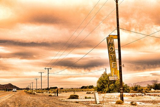 Old Motel sign ruin along historic Route 66 in the middle of California vast Mojave desert.