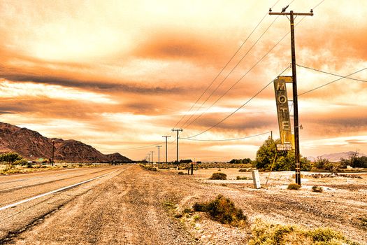 Old Motel sign ruin along historic Route 66 in the middle of California vast Mojave desert.