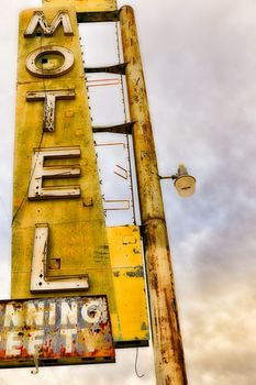 Old Motel sign ruin along historic Route 66 in the middle of California vast Mojave desert.