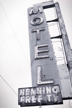 Old Motel sign ruin along historic Route 66 in the middle of California vast Mojave desert.