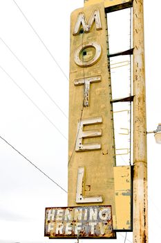 Old Motel sign ruin along historic Route 66 in the middle of California vast Mojave desert.