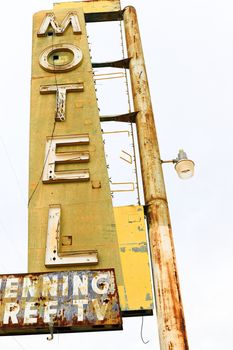 Old Motel sign ruin along historic Route 66 in the middle of California vast Mojave desert.