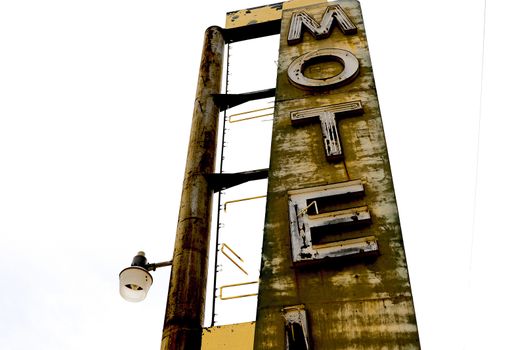 Old Motel sign ruin along historic Route 66 in the middle of California vast Mojave desert.