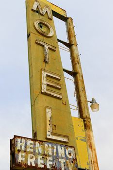 Old Motel sign ruin along historic Route 66 in the middle of California vast Mojave desert.