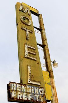 Old Motel sign ruin along historic Route 66 in the middle of California vast Mojave desert.