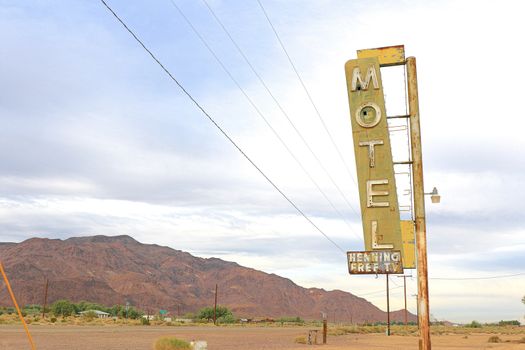 Old Motel sign ruin along historic Route 66 in the middle of California vast Mojave desert.