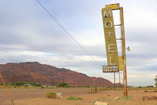 Old Motel sign ruin along historic Route 66 in the middle of California vast Mojave desert.