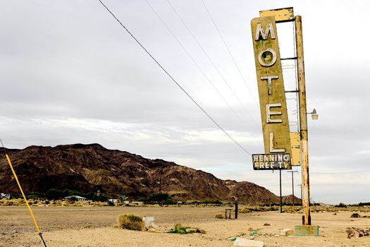 Old Motel sign ruin along historic Route 66 in the middle of California vast Mojave desert.