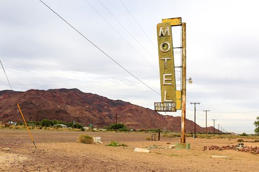 Old Motel sign ruin along historic Route 66 in the middle of California vast Mojave desert.