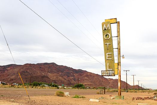 Old Motel sign ruin along historic Route 66 in the middle of California vast Mojave desert.