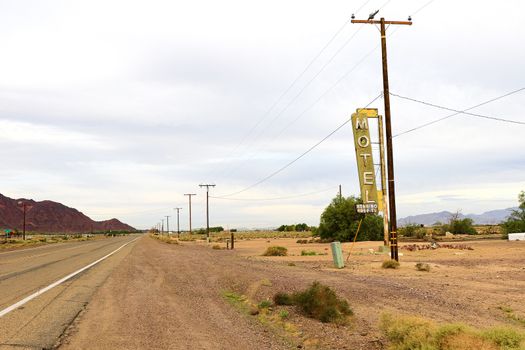 Old Motel sign ruin along historic Route 66 in the middle of California vast Mojave desert.