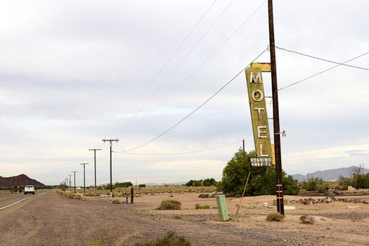 Old Motel sign ruin along historic Route 66 in the middle of California vast Mojave desert.